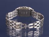 a silver watch that is sitting on a table