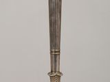 a silver candle holder sitting on a wooden table