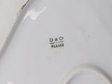 the bottom of a white plate with a black writing on it