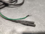 a green and black wire that is on a table