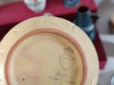 a person holding a yellow plate with a picture on it