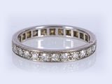Gros plan sur une bague « éternité » sertie de diamants, sur fond blanc
