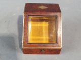a small wooden box with a yellow light inside of it