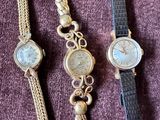 three different types of wrist watches on a purple surface