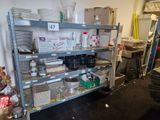 a metal shelf with many items on it in a room