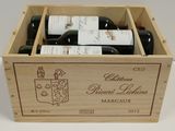 bottles of red wine in a wooden box on a table