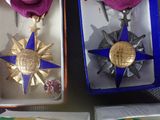 two medals that are in a box on a table