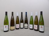 several bottles of wine are lined up on a table