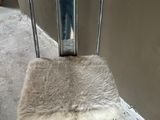 a chair that has a furry seat on the back of it
