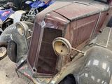 an old car that is sitting in the garage