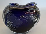 a glass vase that has a blue and silver design on it