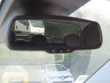 a rear view mirror of a car with a bus in the background