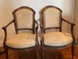 pair of antique carved wood chairs with upholstered upholstered cushions