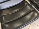 three black leather chairs sitting on a tiled floor next to each other