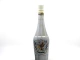 a bottle with a bird on it sitting on a table