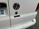 the rear end of a white van with a vw sticker on it