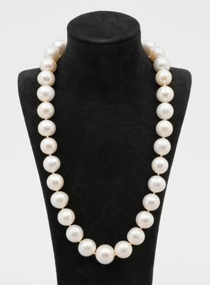 un collier de perles blanches sur un mannequin noir