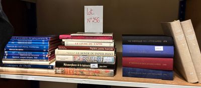 many books on a shelf with a sign on it