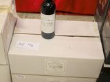 a bottle of wine sitting on top of a stack of boxes
