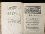 an open book with a picture of a town on it