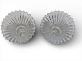 two glass dishes sitting on a white surface
