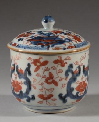 a small blue and red bowl with a lid on a table