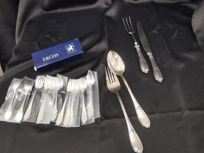 a box of forks and spoons on a table