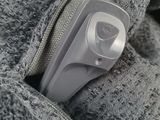 a small object in the pocket of a person ' s jacket
