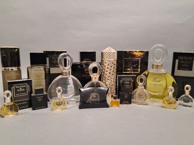 several bottles of perfume are lined up on a white surface