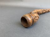 a wooden pipe that is sitting on a table