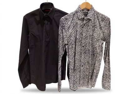 two men ' s shirts hanging on a clothes rack on a white background
