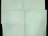 four folded white napkins on a black background