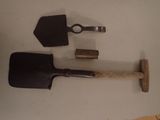 two shovels and a wooden handle on a table