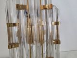 a glass and brass chandelier hanging on a wall