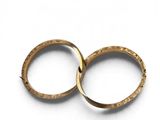 pair of gold wedding rings on a white background