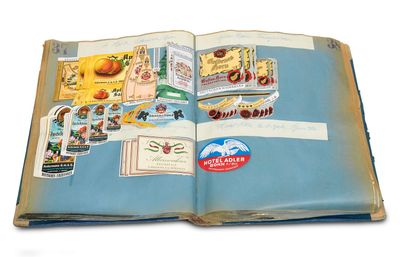 an open book with stickers on it on a white surface