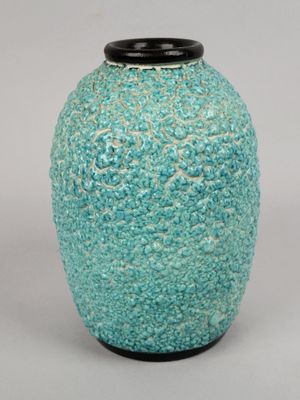 a blue vase with a black lid sitting on a table