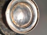 a close up of a silver tea pot on a table