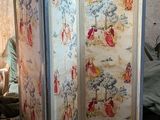 a room divider with a painting on it in a room