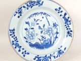 an image of a blue and white plate with flowers on it