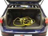 the trunk of a blue car with a bunch of wires in it