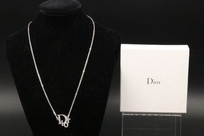 a white necklace and a black necklace on a mannequin stand