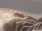 a close up of a silver object with a bird on it