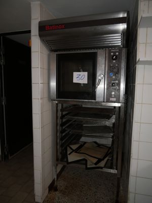 a metal oven that is in the middle of a room