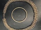 a close up of a bracelet and a ring on a table