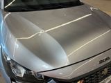 a silver car that is parked in a garage
