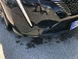a black car that is parked on the side of the road