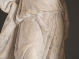 a statue of a woman holding a flower in her hand