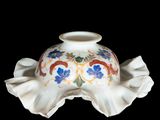 a white vase with a colorful design on it