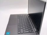 a laptop computer sitting on a white surface with a blue sticker